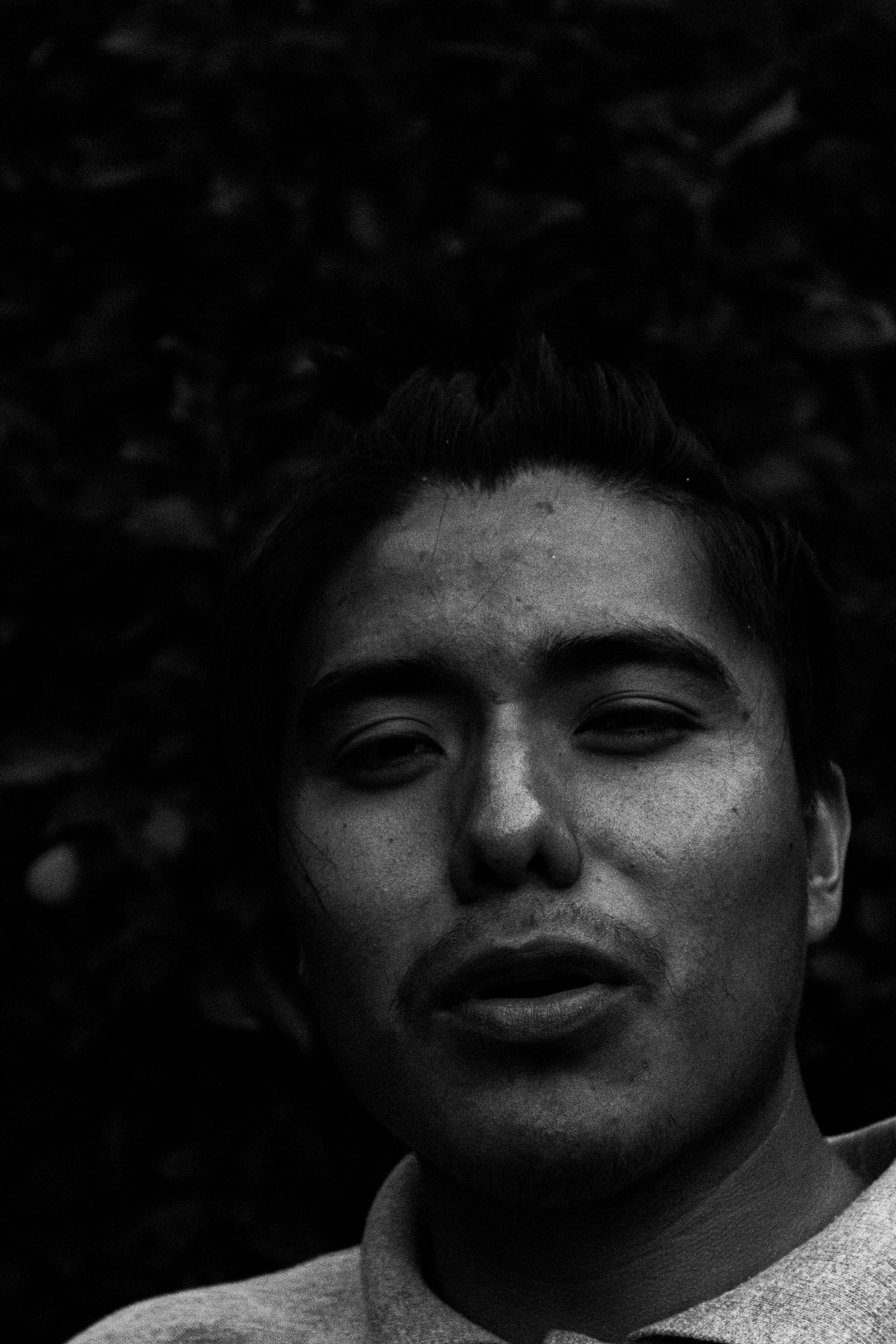 Expressive black and white portrait of a man with a contemplative look.
