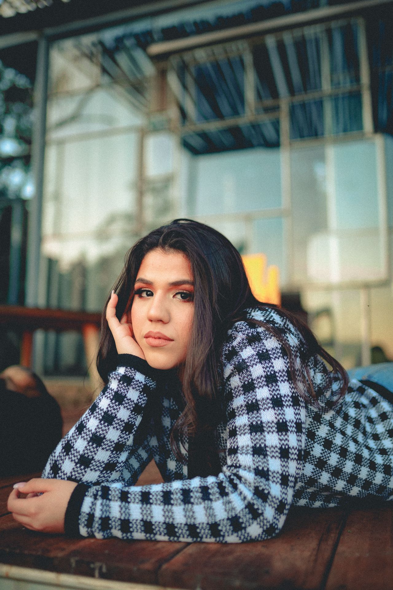 Woman wearing a black and white gingham check knit sweater