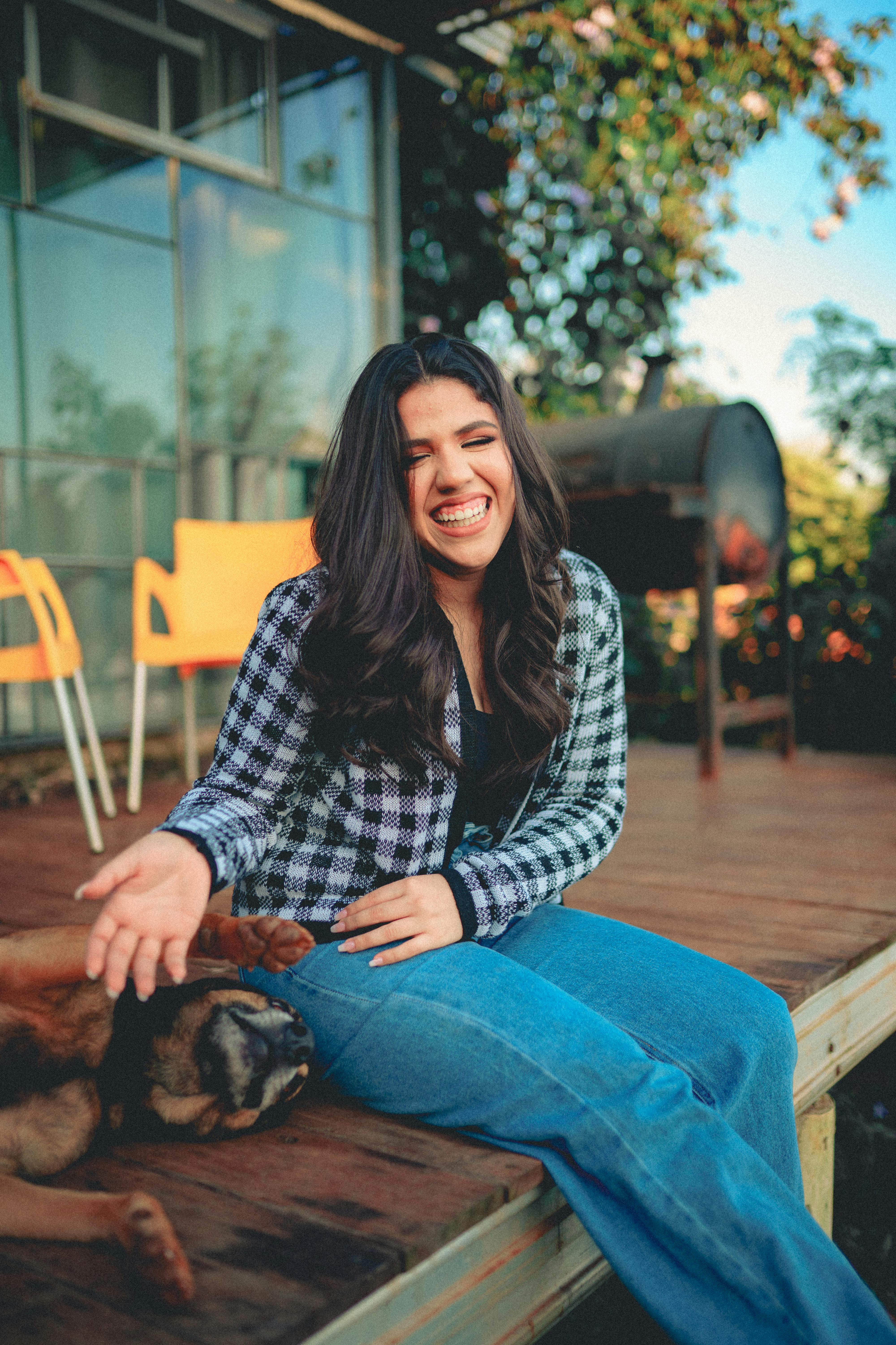 a woman sitting on a porch with her dog