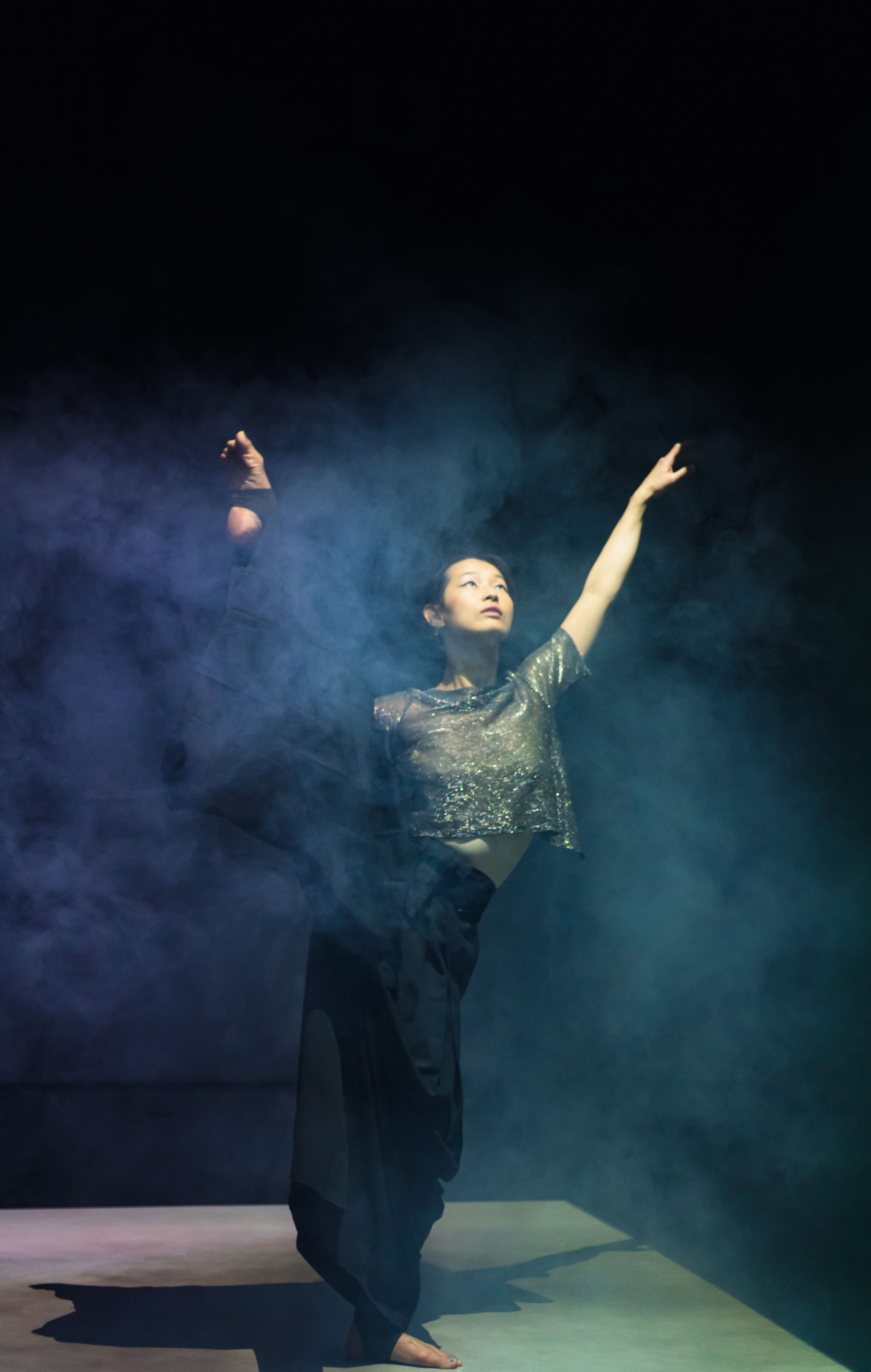 Dancer Performing on a Smoky Stage · Free Stock Photo
