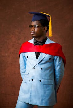 Portrait of a man in graduation attire, showcasing elegance and style indoors.