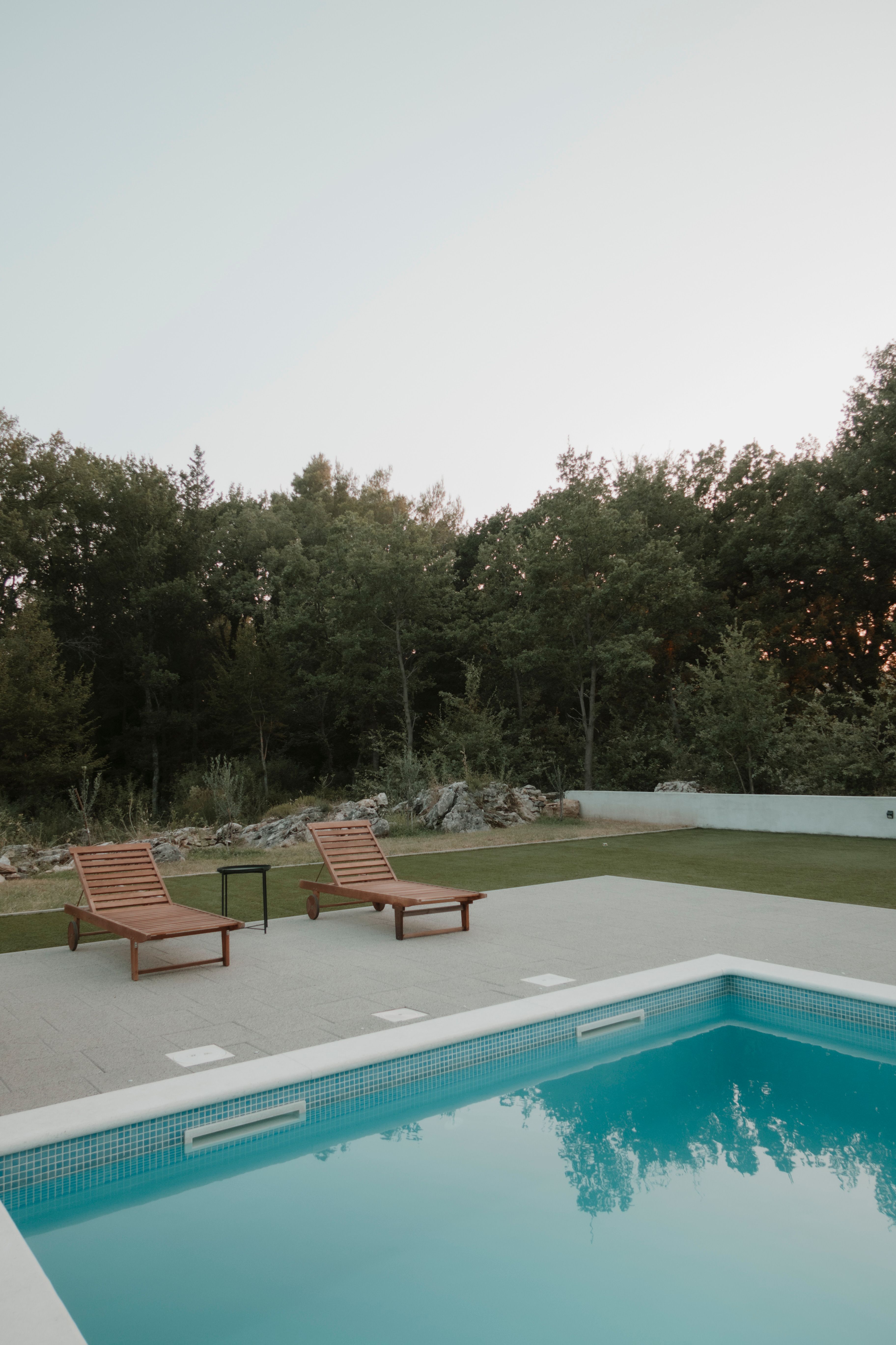 Brown Lounge Chair on Side of Swimming Pool · Free Stock Photo