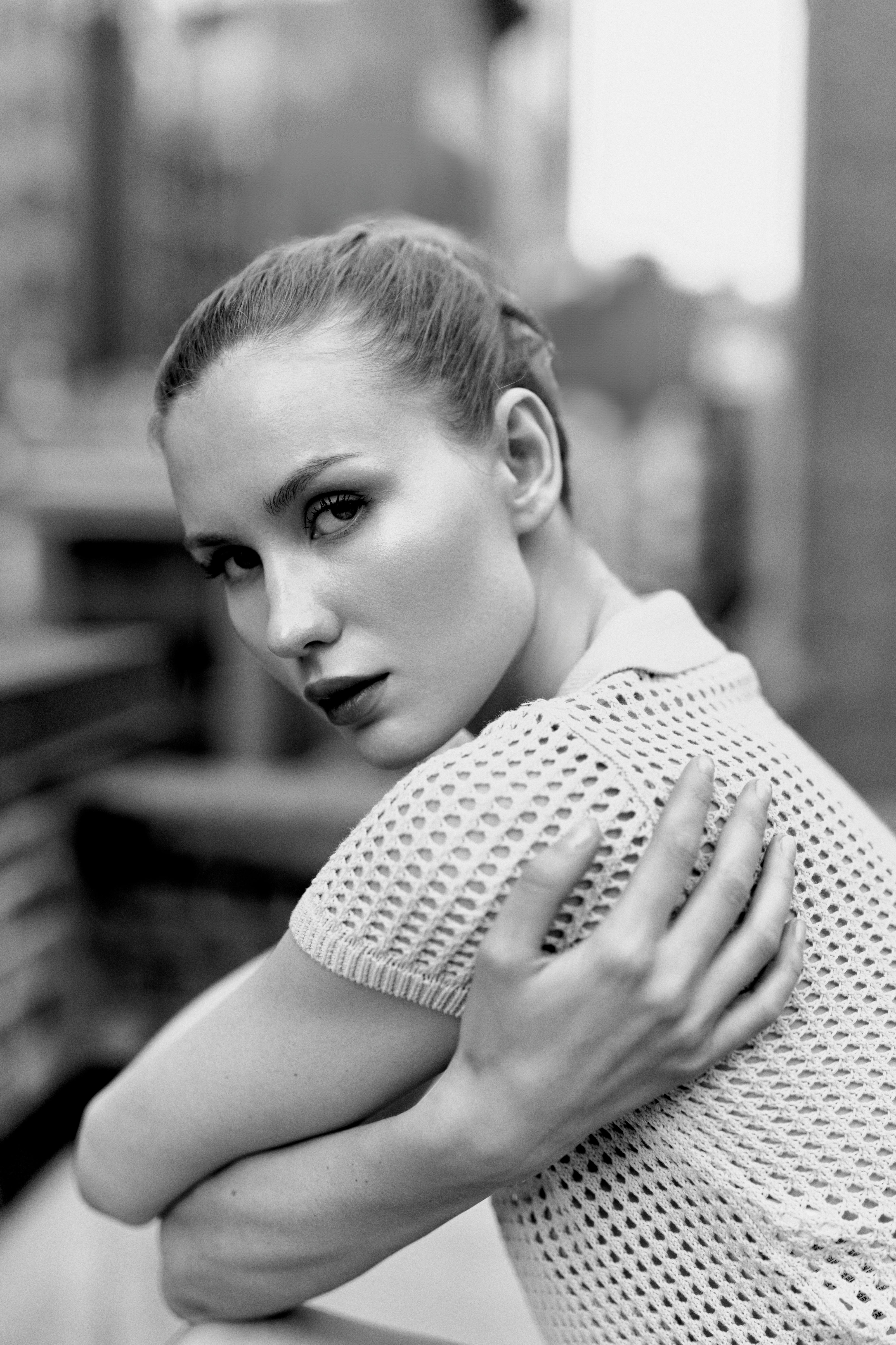 a woman with her arms crossed in front of her