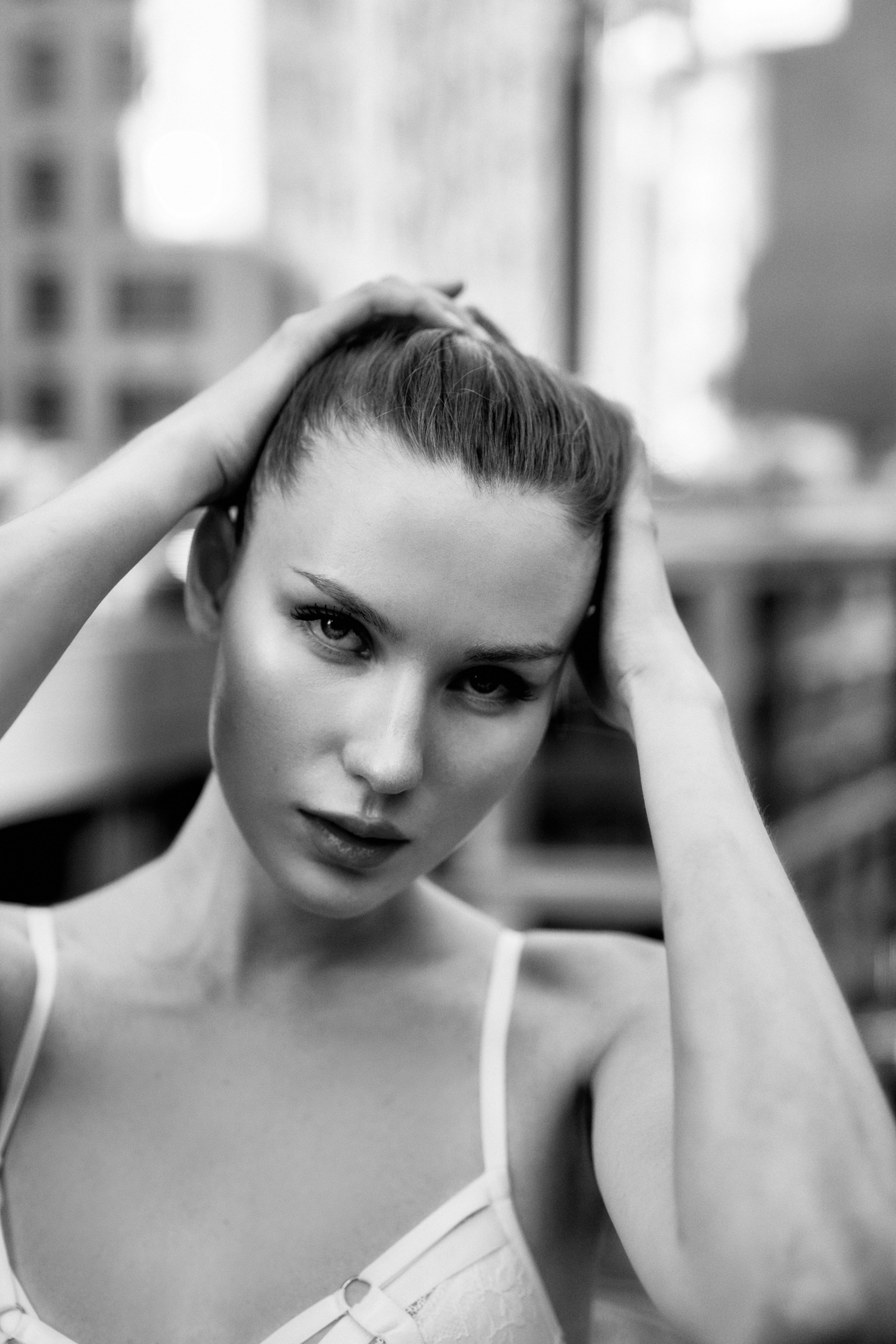 a woman in a bra top is posing for a black and white photo