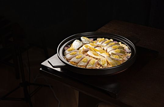 Delicious fish dish garnished with lemon and garlic, ready for a gourmet meal.