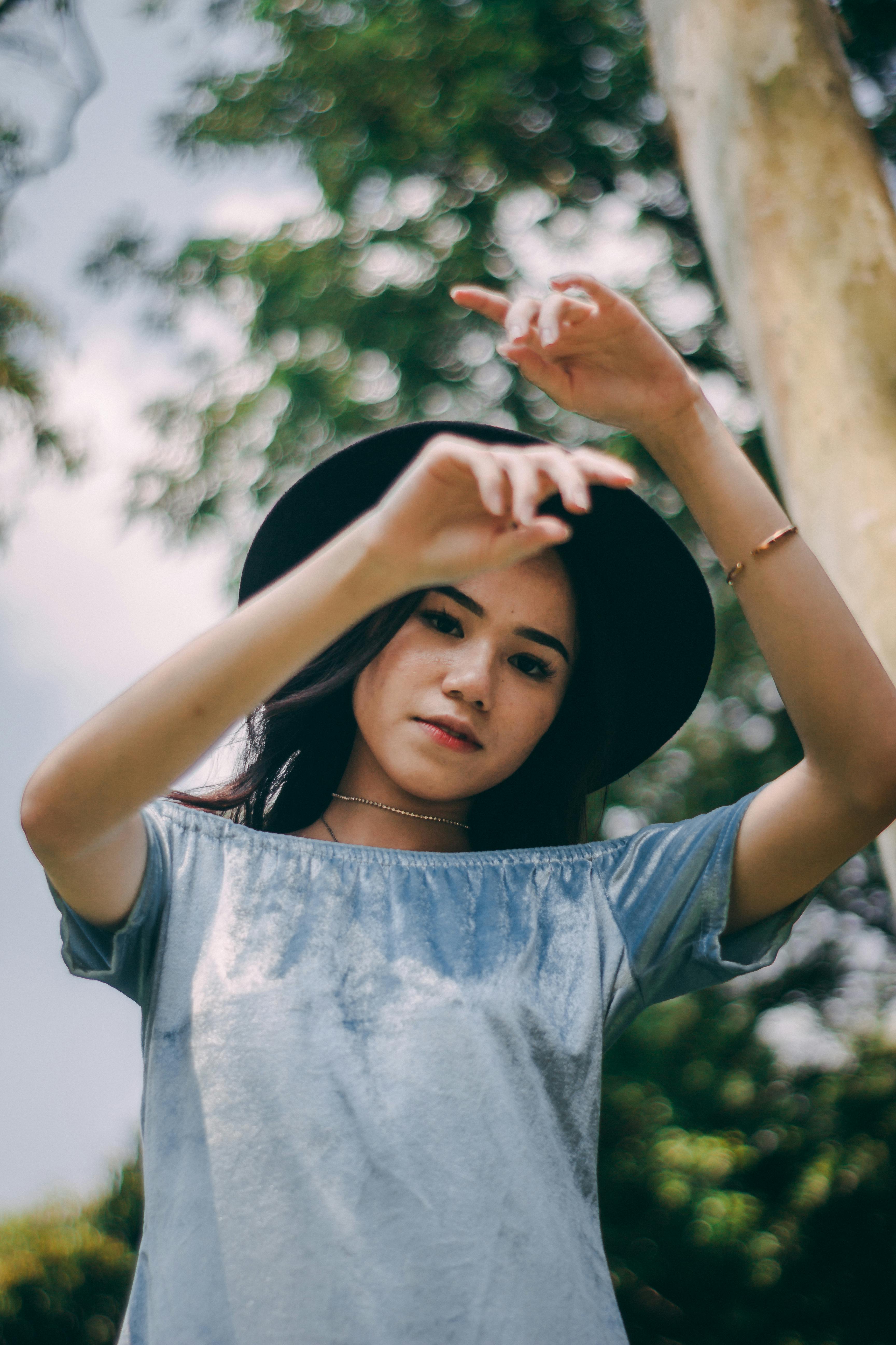 Woman Wearing A Black Hat With Hands Up · Free Stock Photo