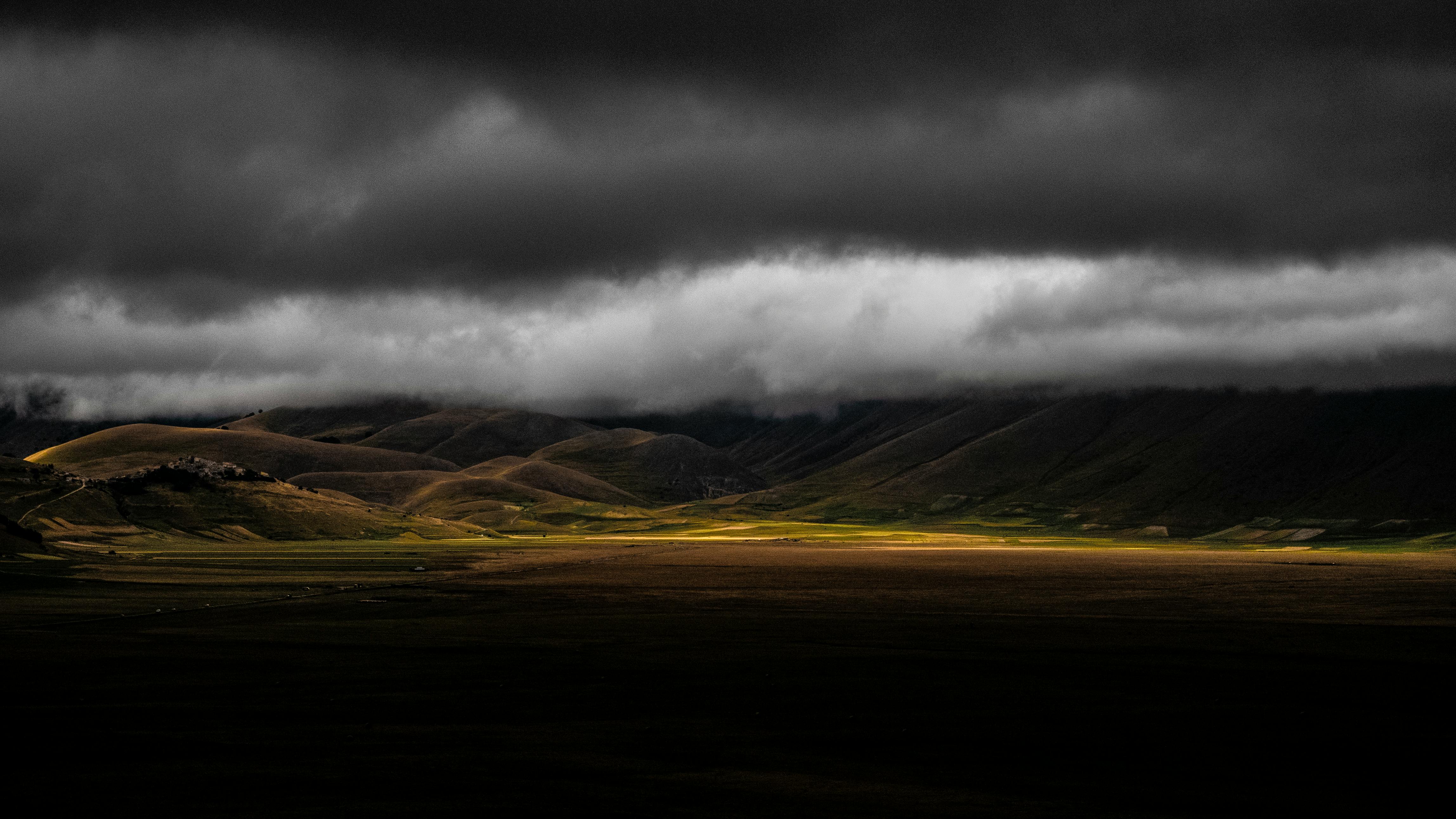 scenic view of mountains under cloudy sky