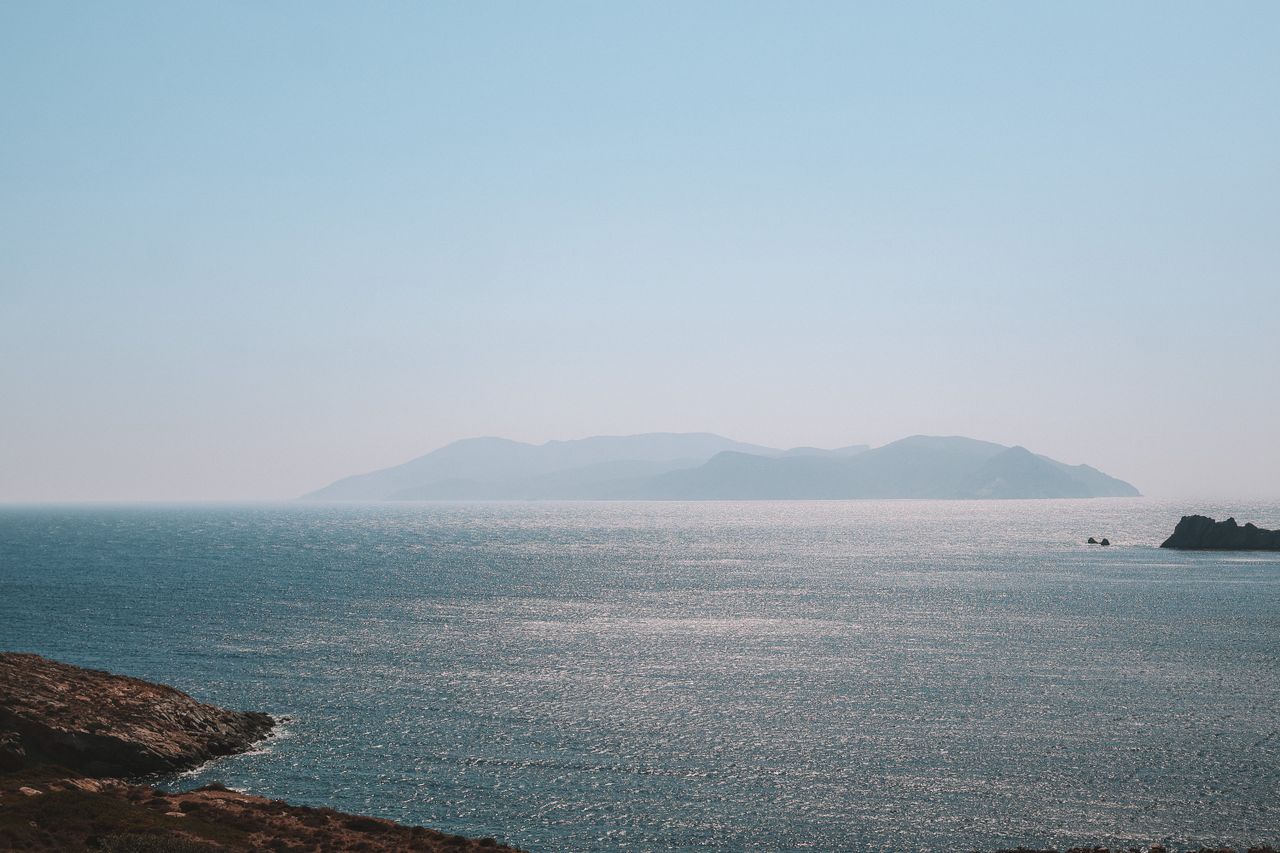 peaceful view of the aegean sea with distant greek islands under a cle