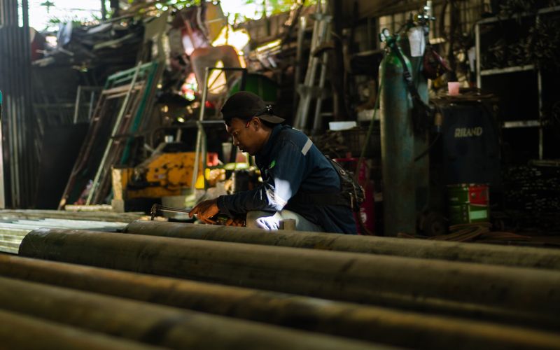Skilled tradesperson working with tools in an industrial workshop