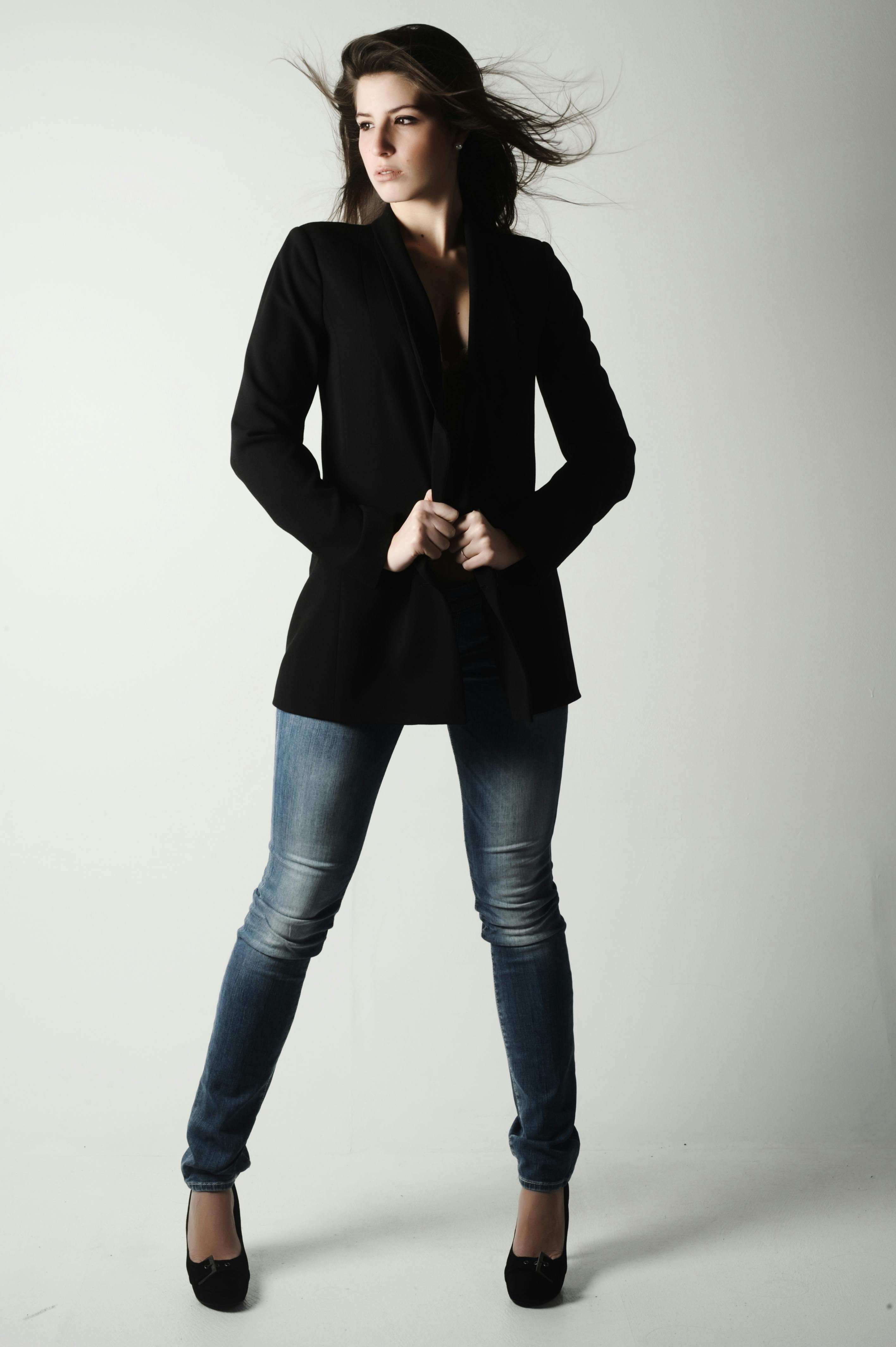 a woman in jeans and a black blazer