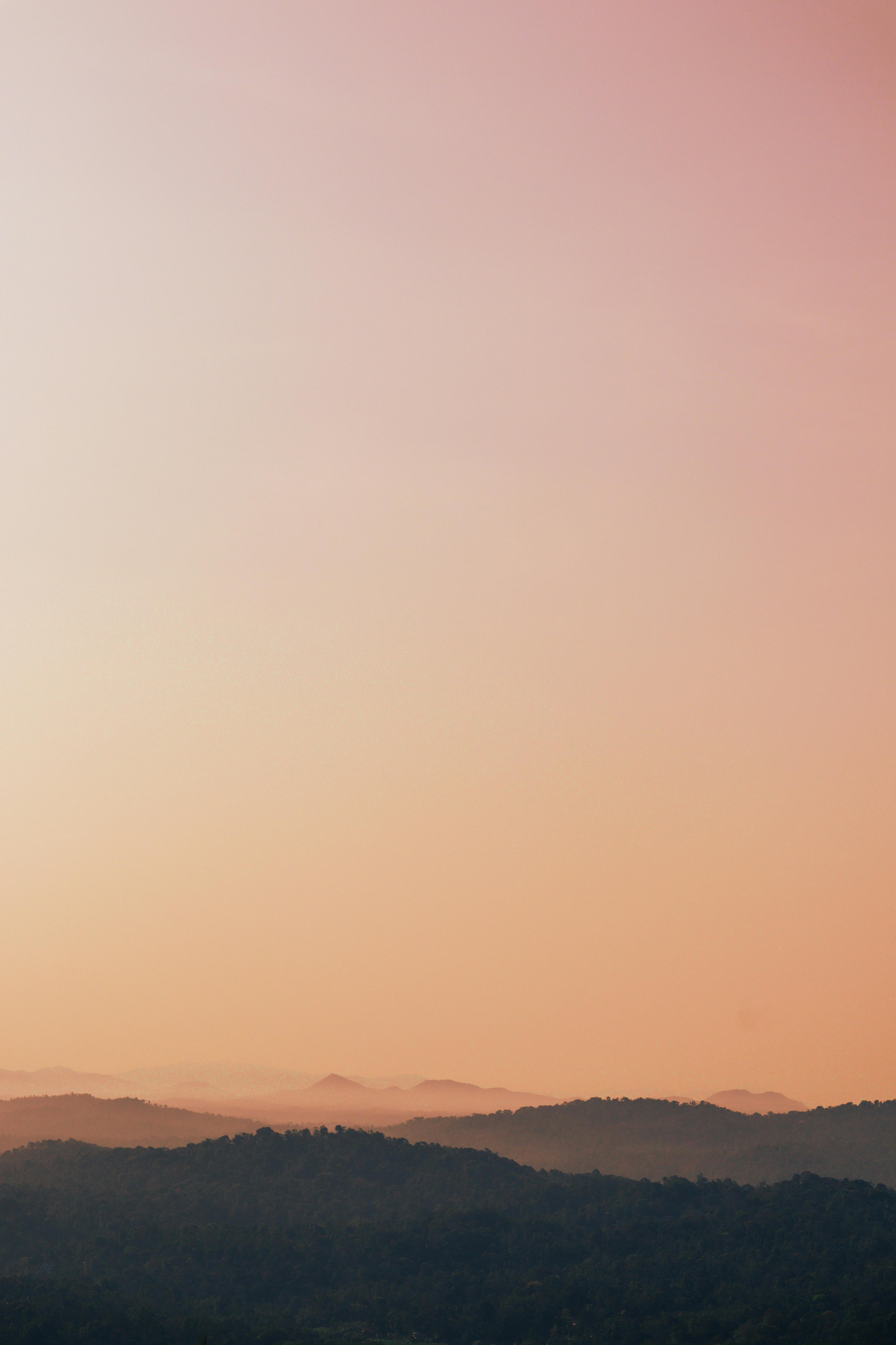 Captivating view of Munnar hills at sunset with a warm and serene atmosphere.