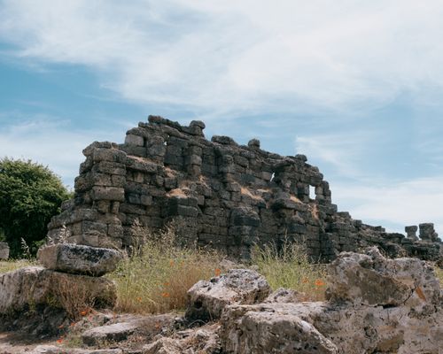 Free Explore the ancient ruins of Side, Antalya with stunning stone architecture under a clear blue sky. Stock Photo