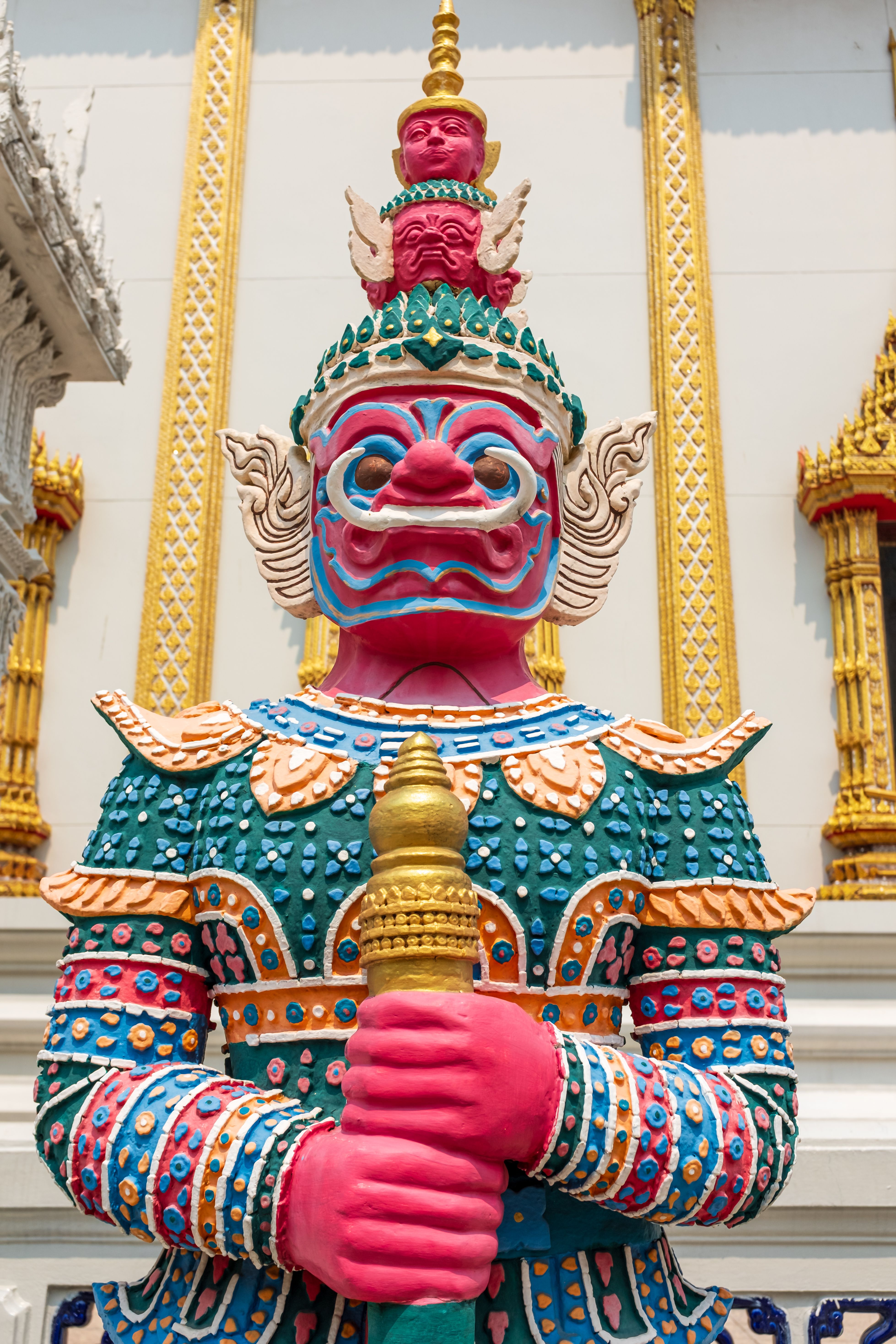 A statue of a colorful character in front of a building · Free Stock Photo