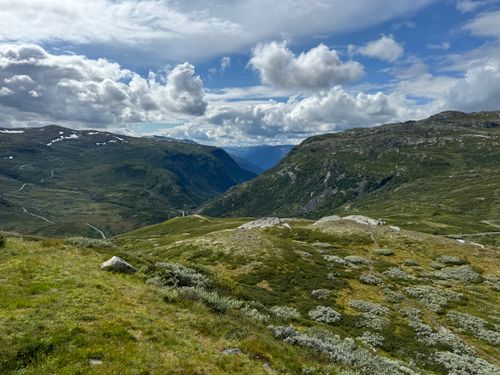 Free Captivating panoramic view of a lush mountainous valley under a dramatic sky in summer. Stock Photo