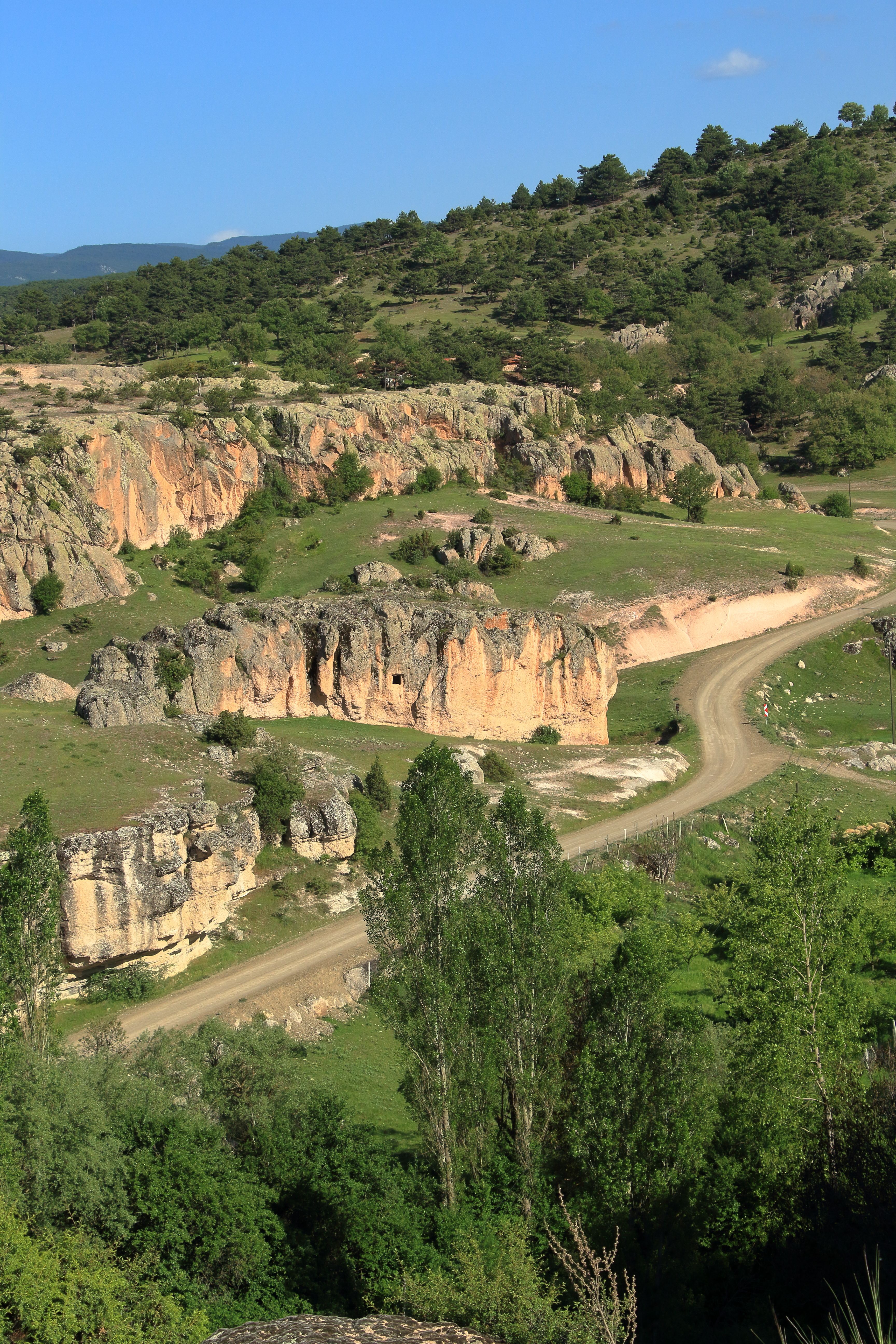 Breathtaking summer landscape featuring winding road through rocky hills.