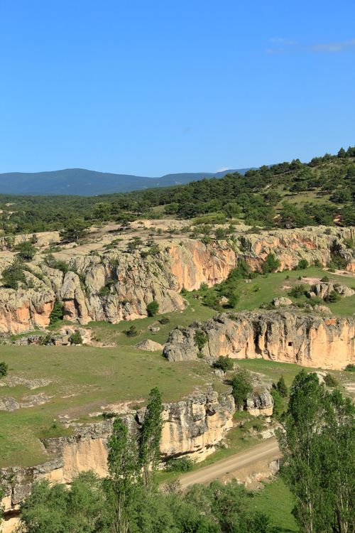 Free Explore breathtaking rocky cliffs amidst lush greenery, perfect for nature travel in summer. Stock Photo