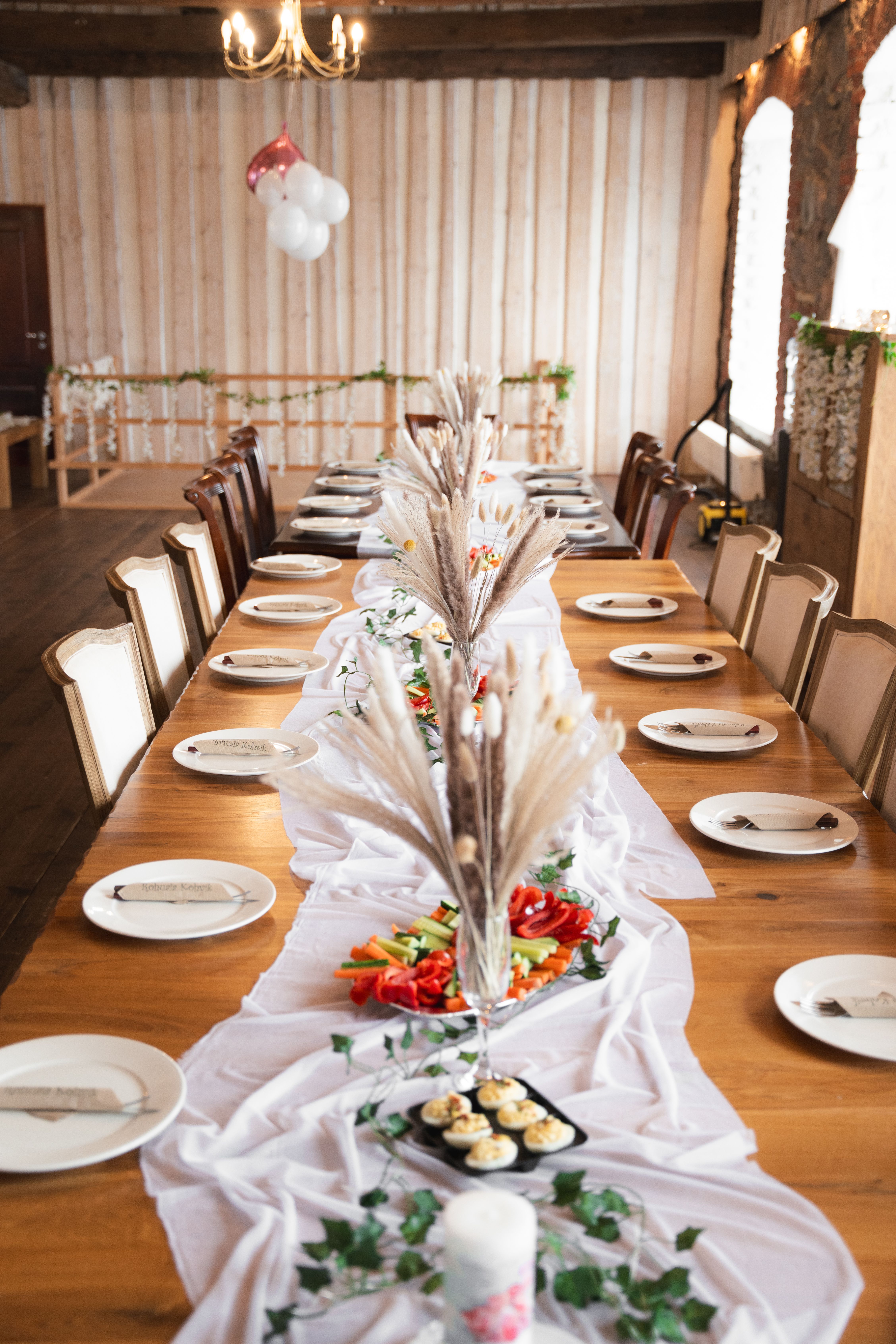 A beautifully arranged dining table for a wedding reception with elegant decorations.