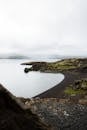 View Of An Island's Shore With Black Sand