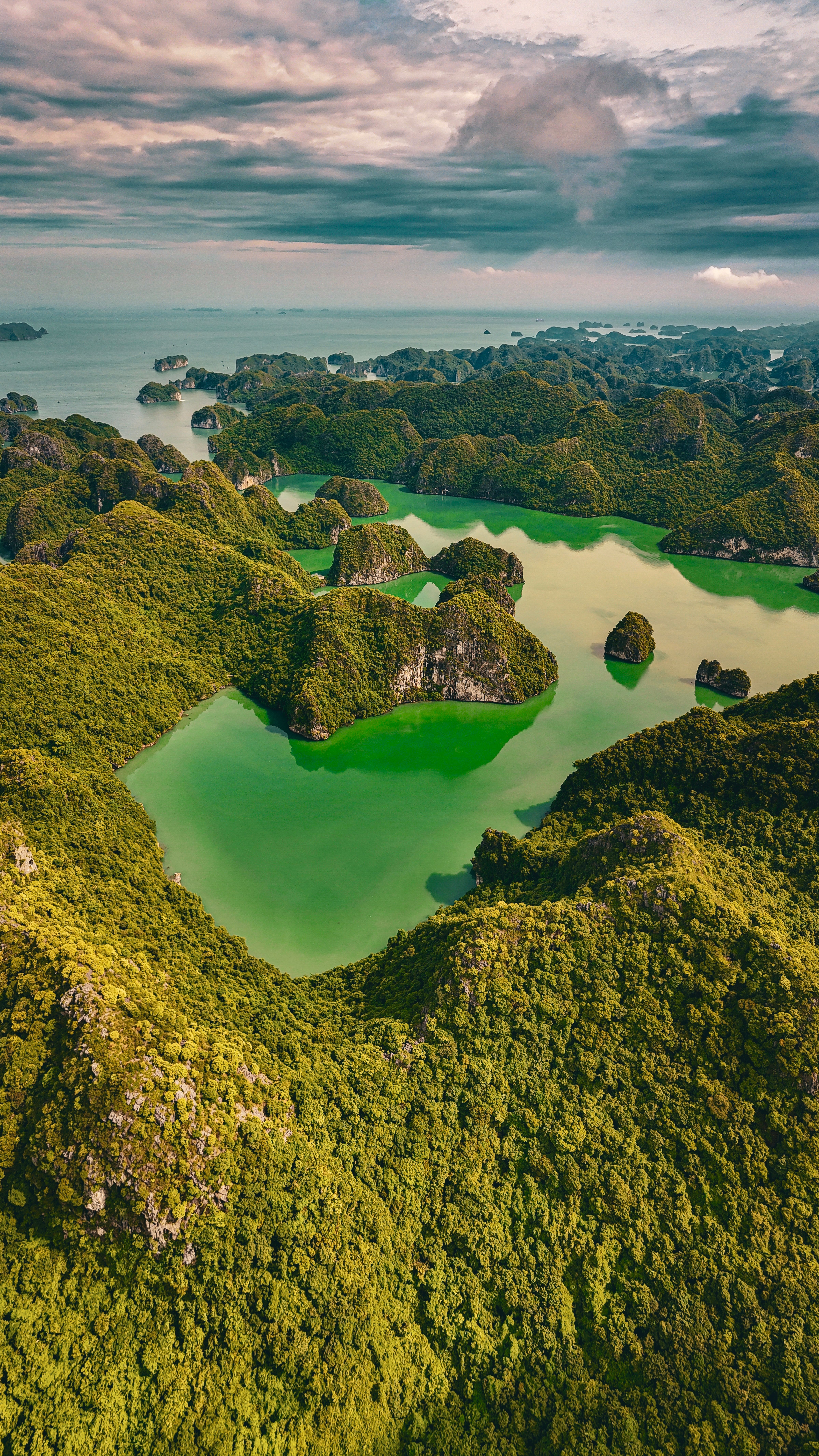 A breathtaking aerial view of Ha Long Bay's emerald waters and lush islands in Vietnam.