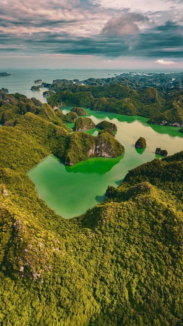A breathtaking aerial view of Ha Long Bay's emerald waters and lush islands in Vietnam.