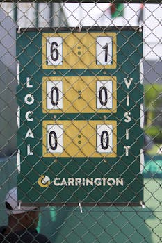 A tennis scoreboard with iron fence in Belas, Luanda, Angola captured from behind.
