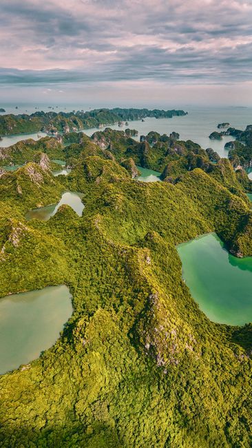 Breathtaking aerial view of green islands and emerald waters in Halong Bay, Vietnam.
