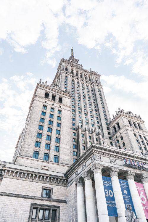 Free Impressive view of the iconic Palace of Culture and Science in Warsaw against a bright sky. Stock Photo