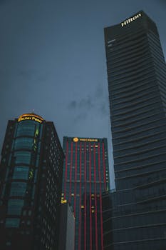 View of Ho Chi Minh City skyscrapers at night, showcasing modern architecture and vibrant city lights.