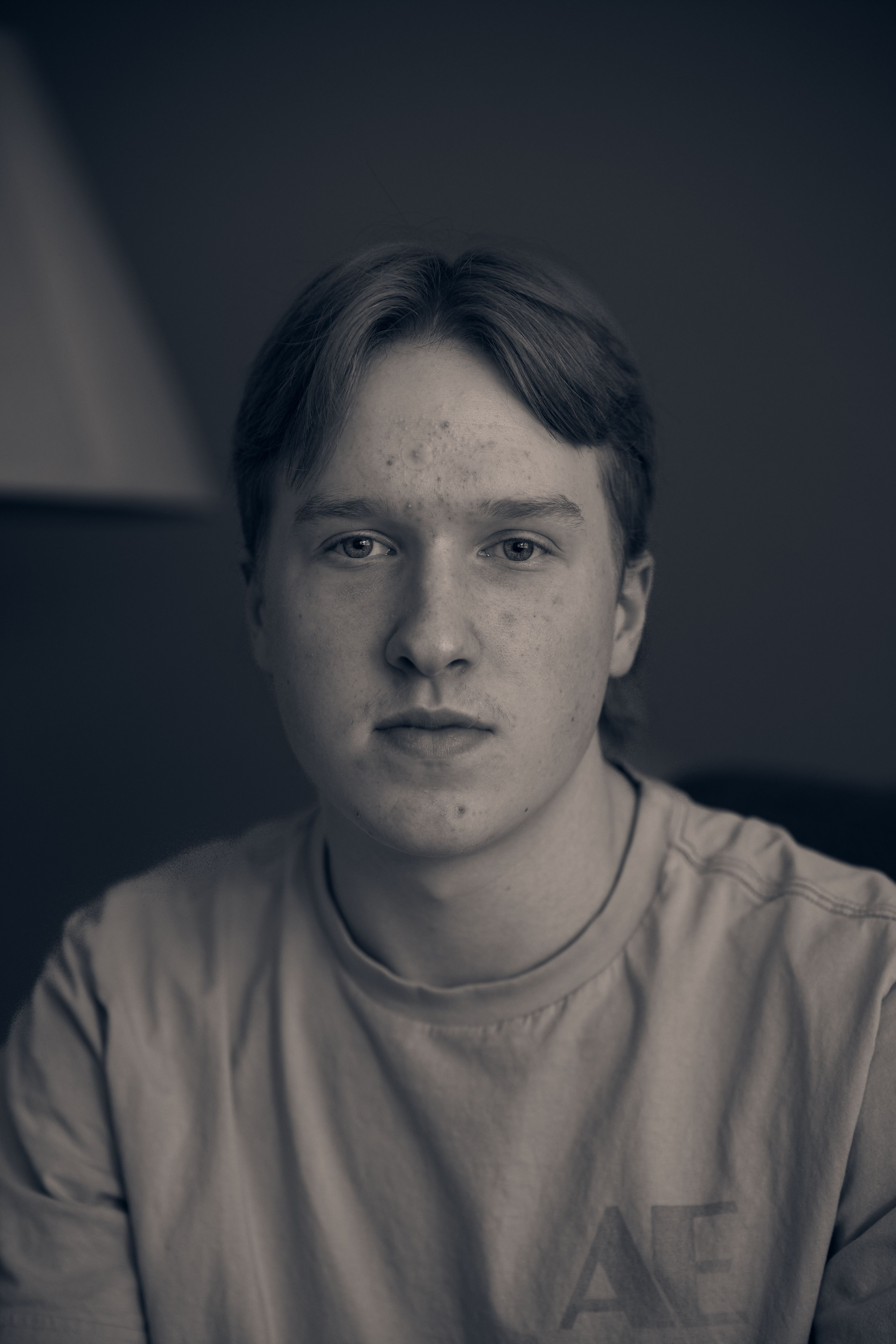 Serious young man in a moody monochrome portrait, London, Canada
