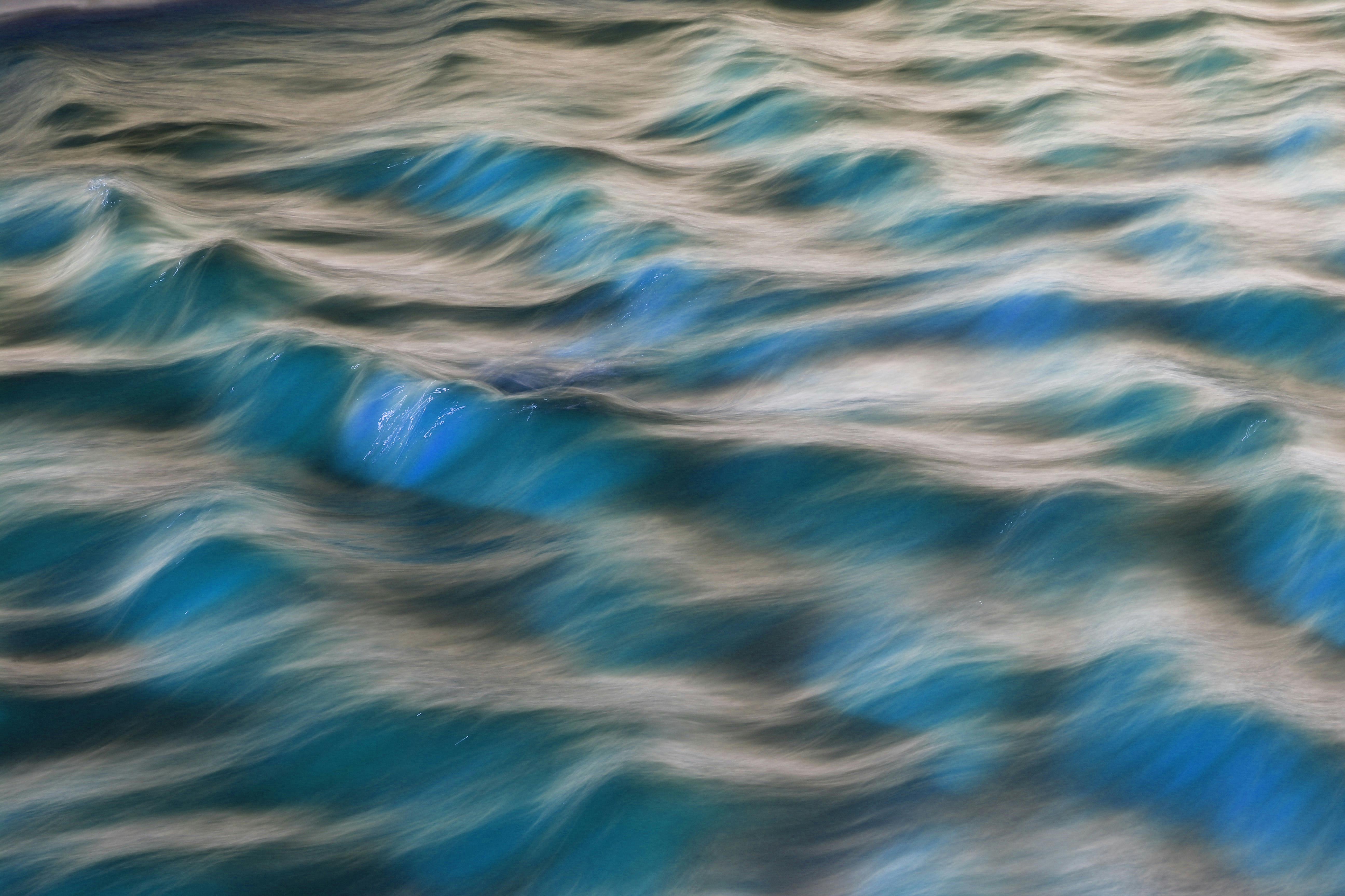 Capture of turquoise ocean waves in motion, showcasing natural beauty in Guaratuba, Brazil.