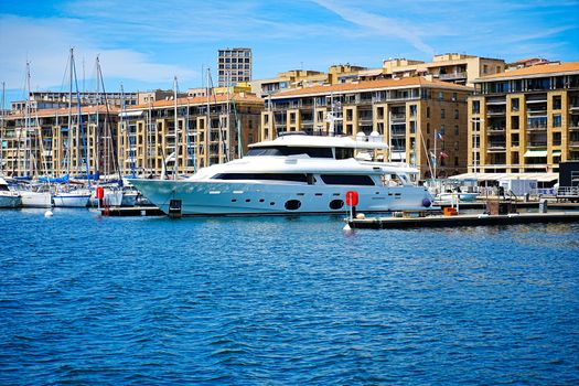 Explore a luxury yacht docked in the vibrant Marseillan harbor in Occitanie, France, showcasing elegance and travel allure.