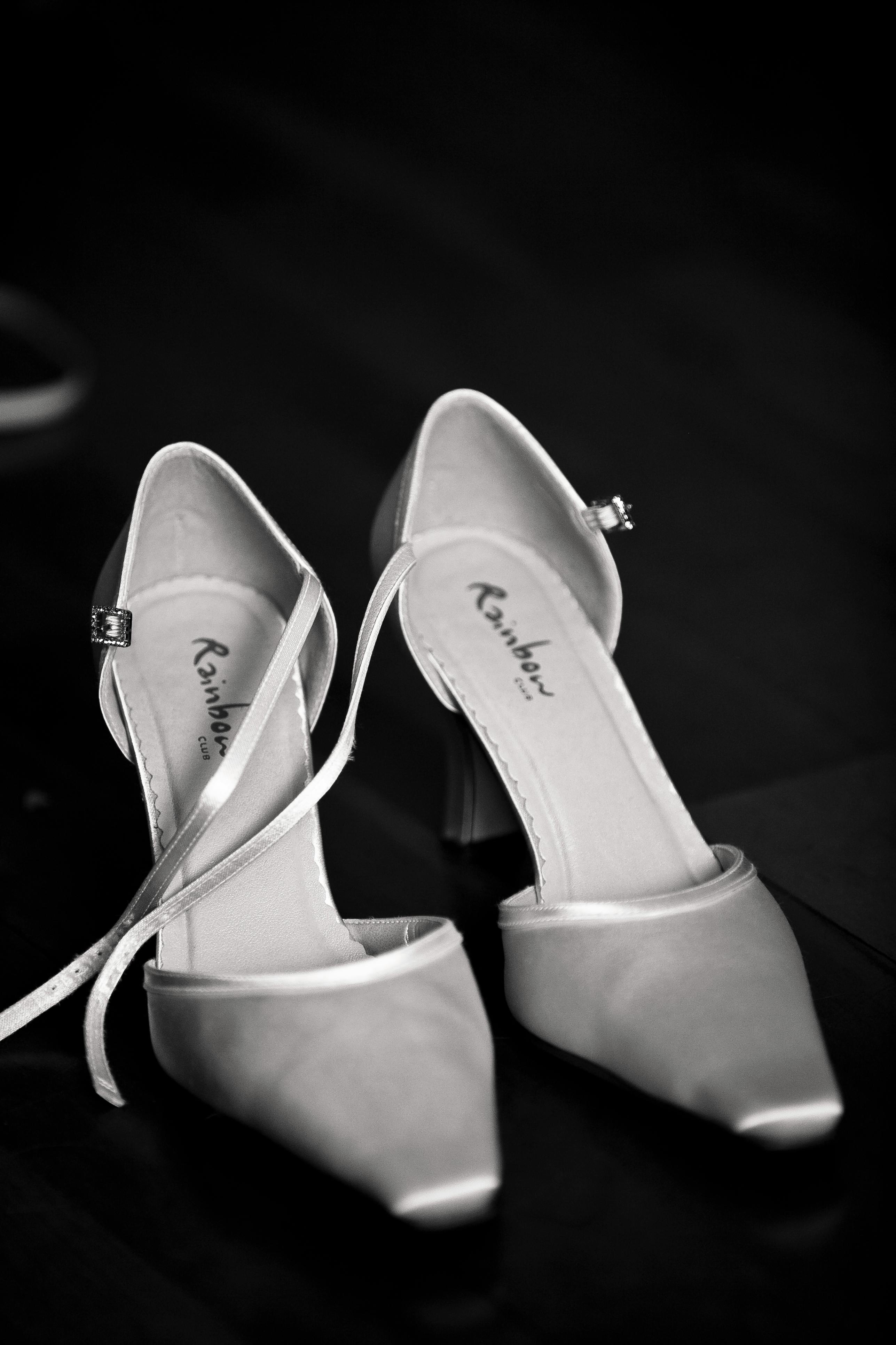 gray rainbow heeled sandals on black surface