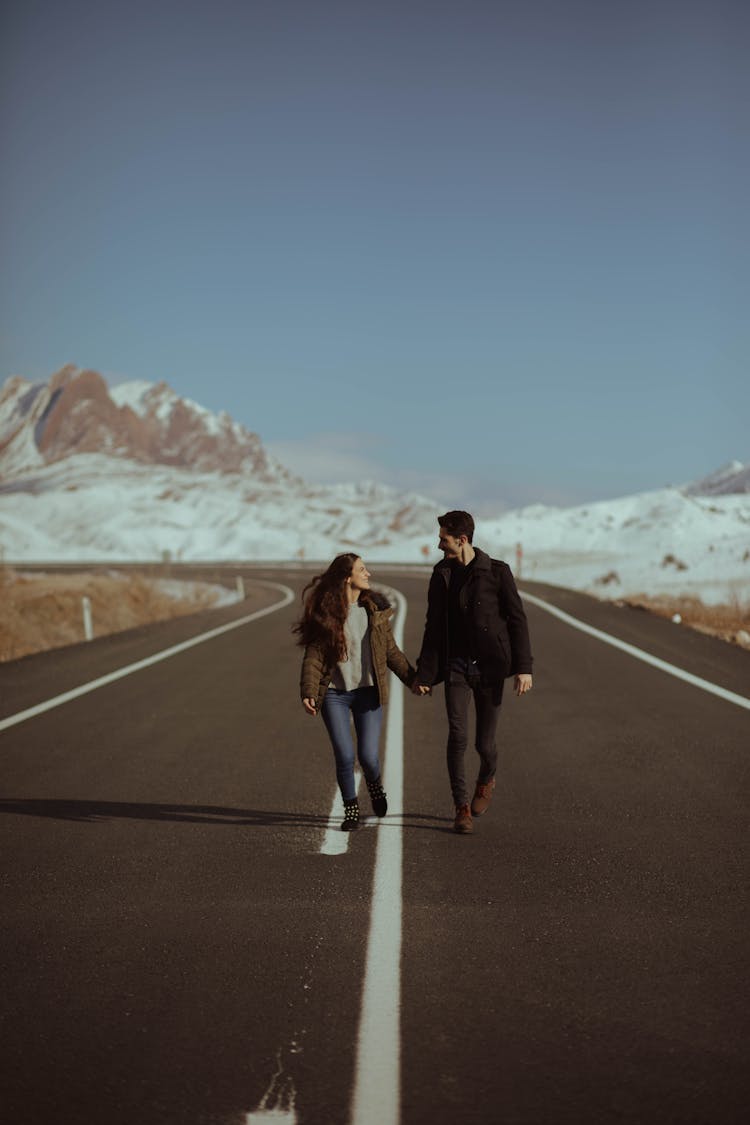 Man And Woman Walking On Road