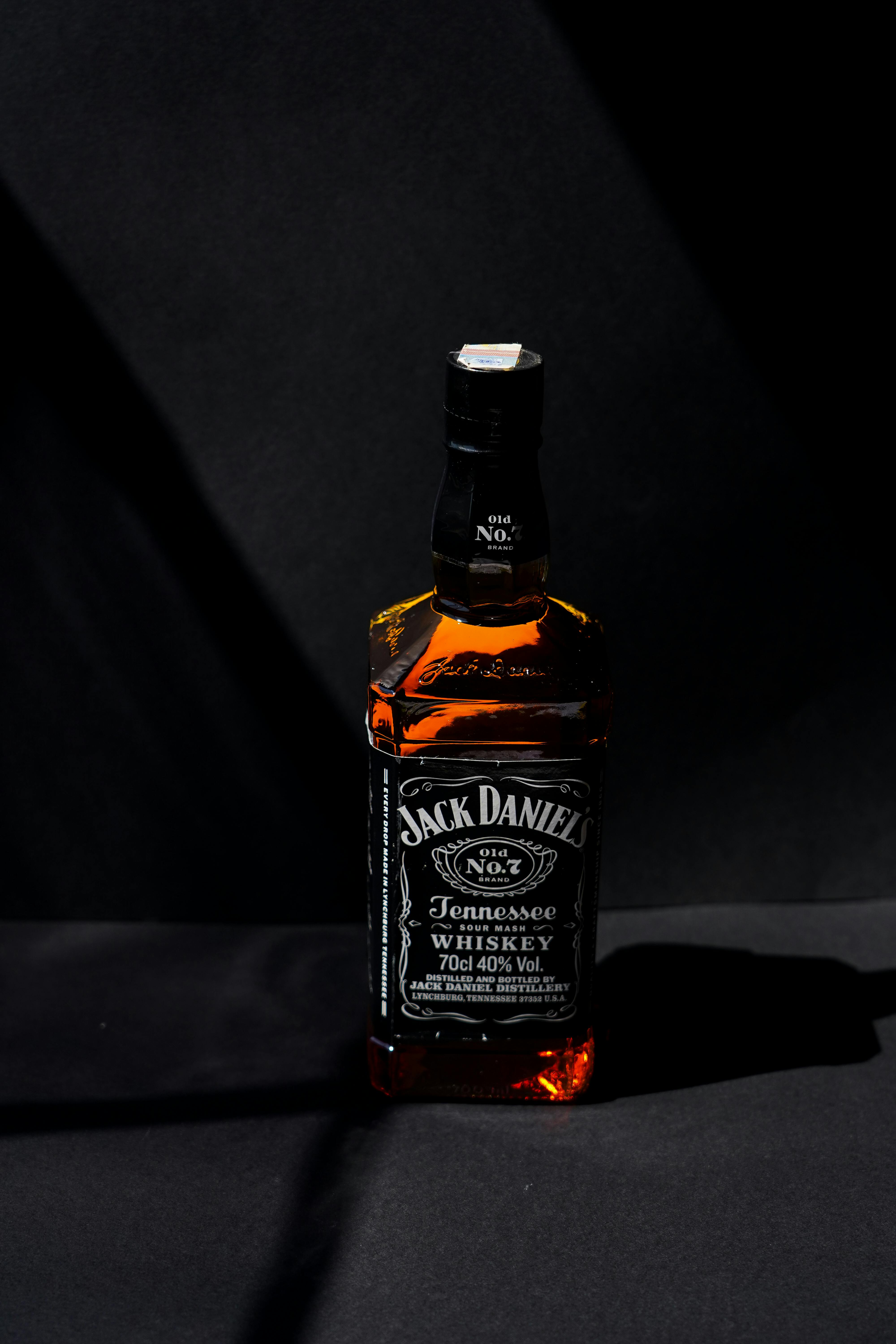 Classic Jack Daniel's Tennessee Whiskey bottle captured with dramatic lighting.