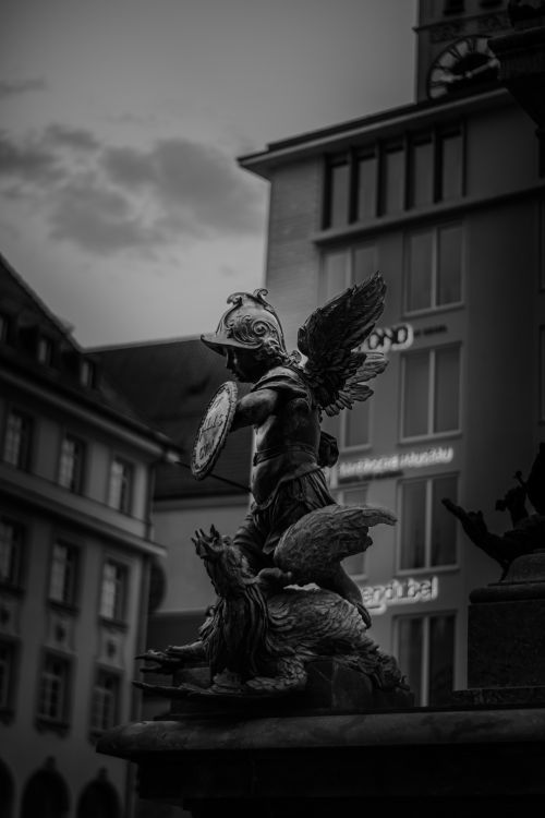 Free Dramatic monochrome photo of an angel statue in Munich's architectural setting. Stock Photo