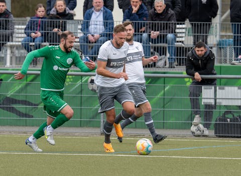 Players compete fiercely during a soccer match, showcasing skill and teamwork.