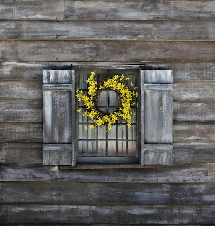 Yellow Flower Wreath On An Old Wooden Window 