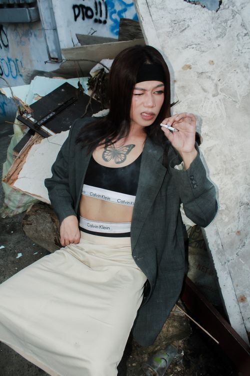 Free Edgy street fashion portrait of a woman in an urban setting with graffiti backdrop. Stock Photo