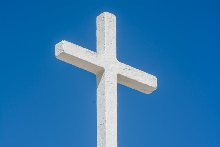 A White Cross On A Blue Sky Background