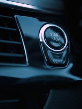 Detailed shot of a car's start-stop button, emphasizing modern automotive technology.