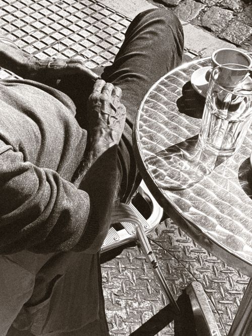 Free Black and white street view of an elderly person in a Buenos Aires cafe. Stock Photo