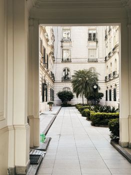 A classic courtyard in Buenos Aires showcasing elegant architecture and lush greenery.