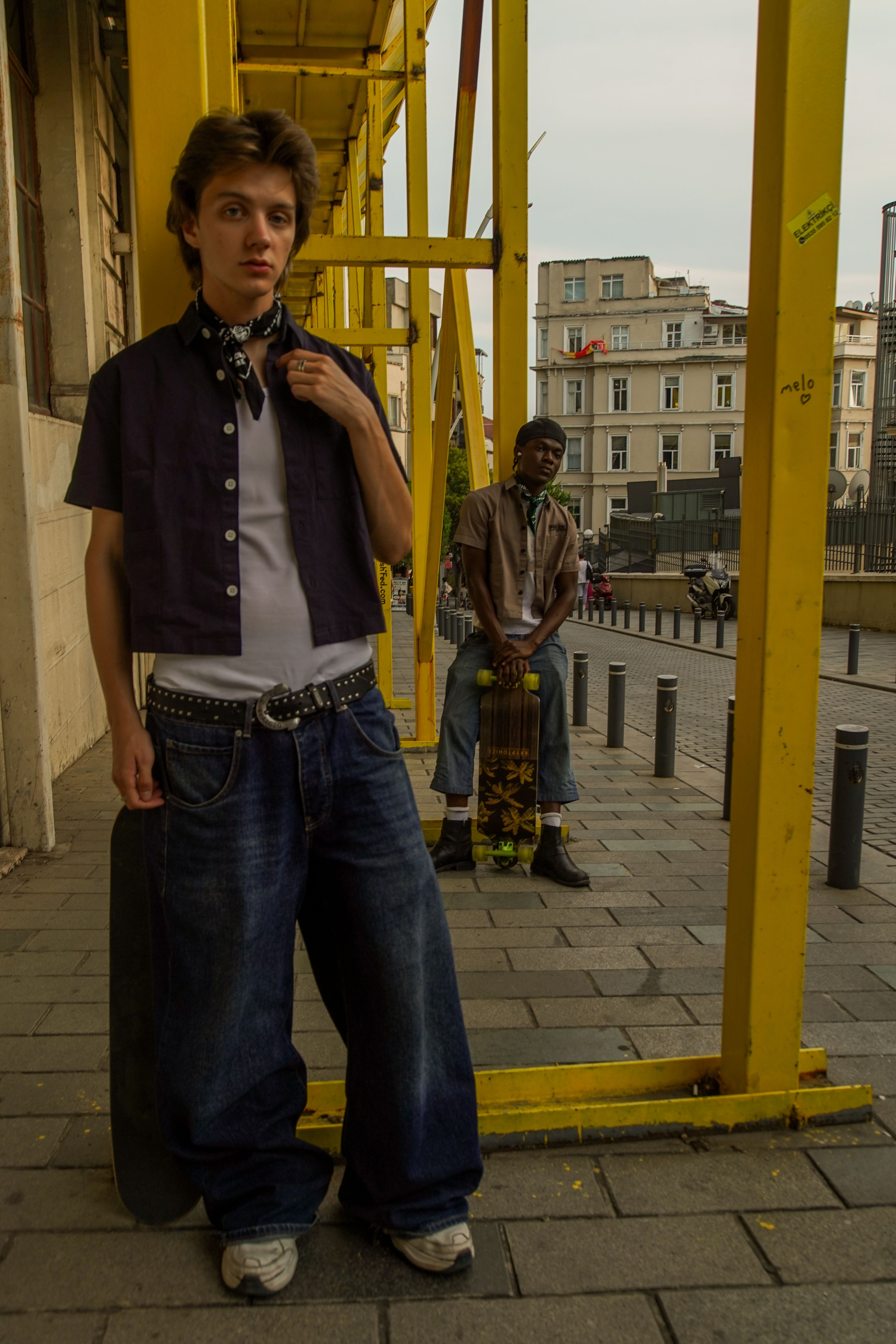 Young skaters pose in an urban setting, showcasing street fashion and lifestyle.