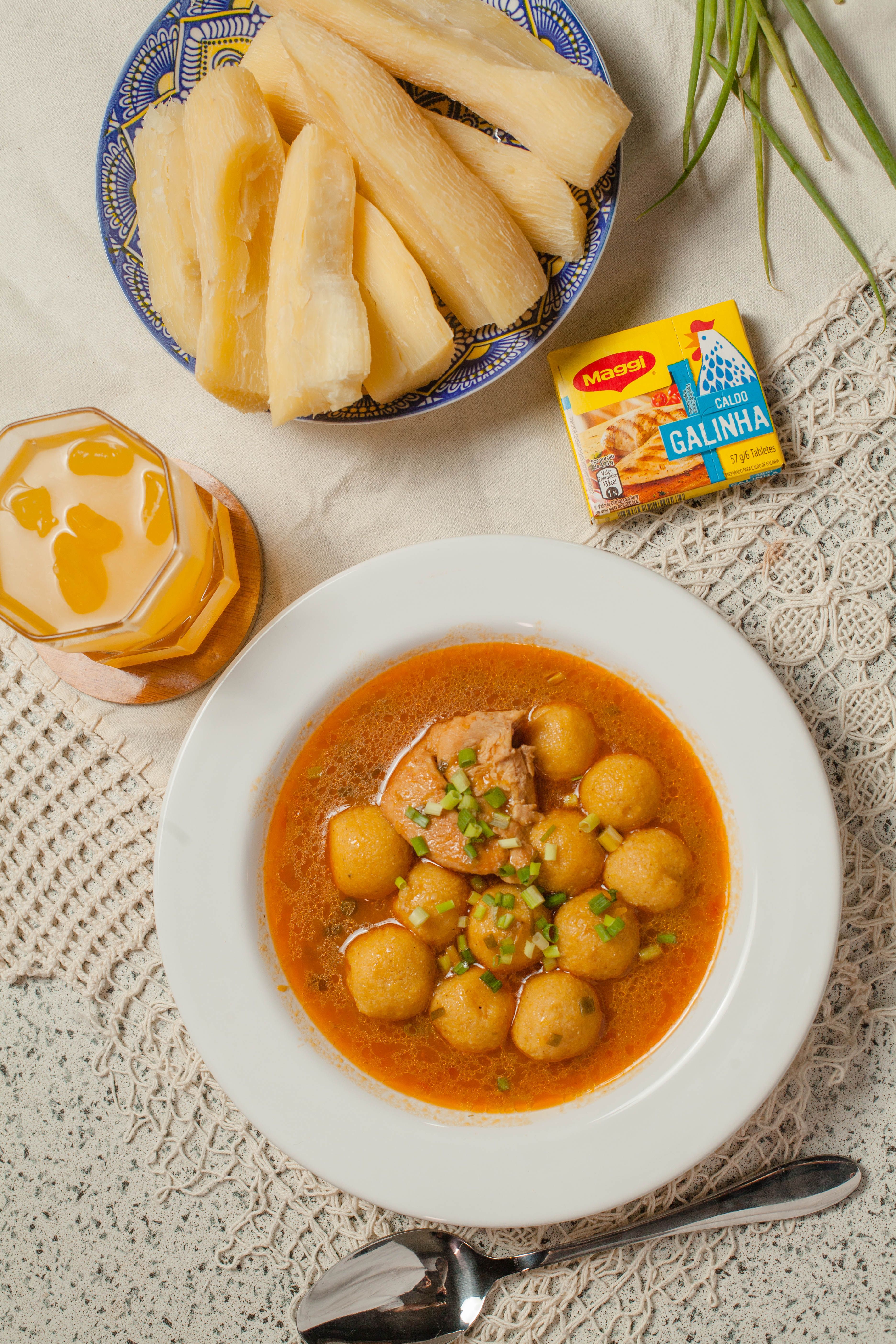 Delicious homemade Paraguayan soup with yucca and chicken served on a lace tablecloth.
