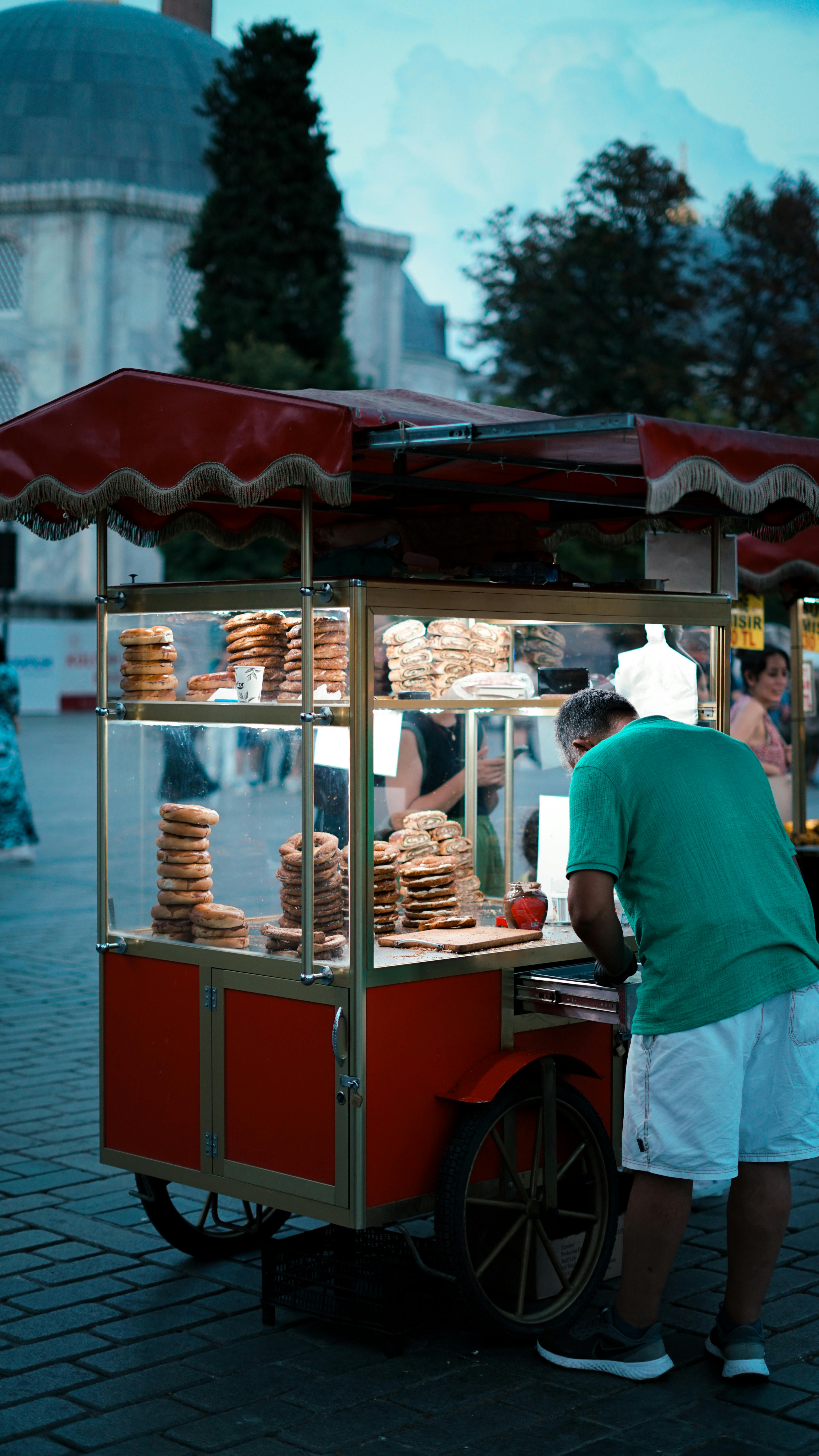 a man selling food at night in a city