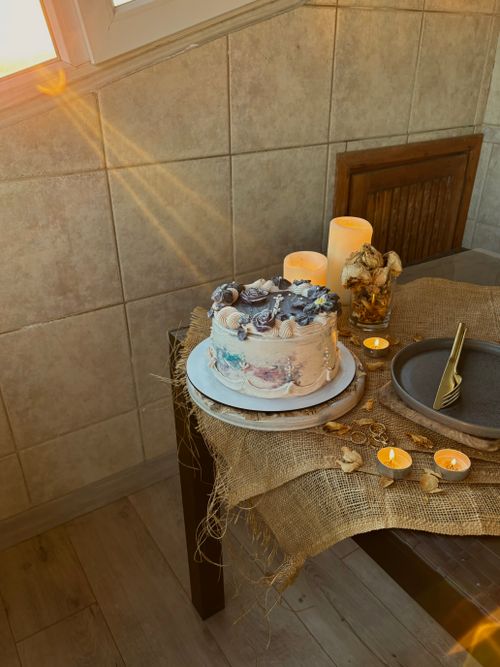 Free Elegant cake with rustic decor lit by warm sunlight in a cozy setting. Stock Photo