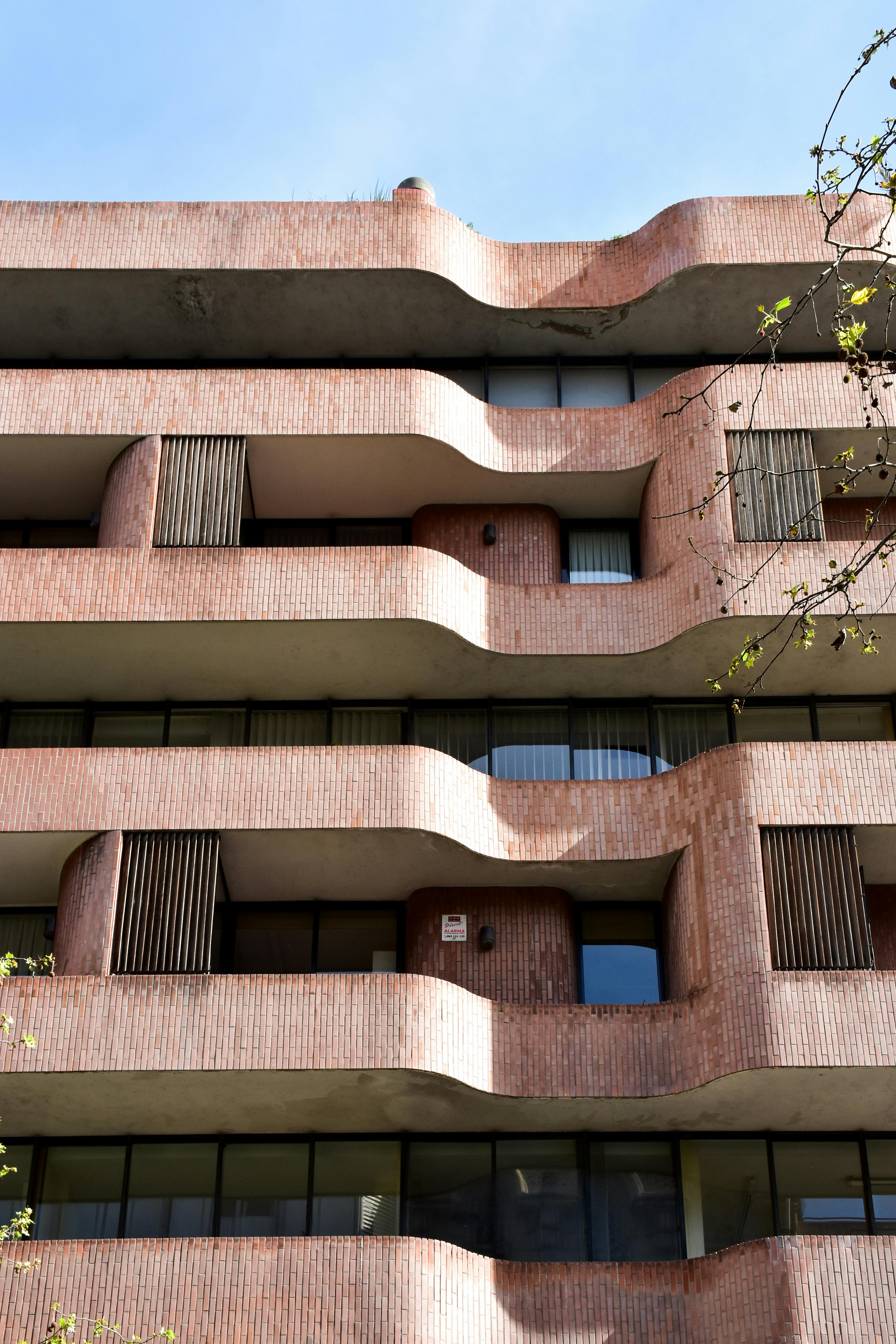 a building with a curved facade and balconies