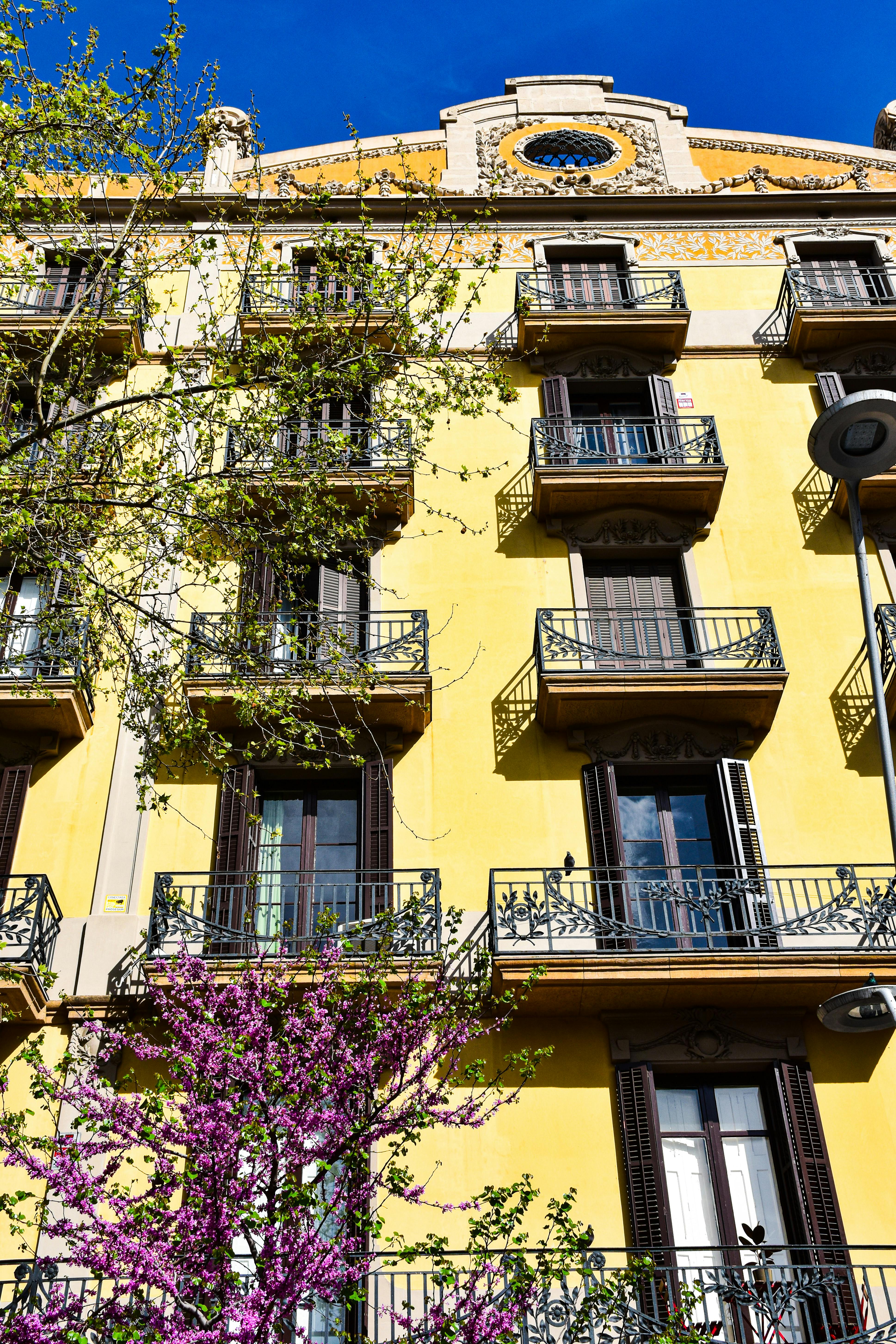 a yellow building with balconies and balconies