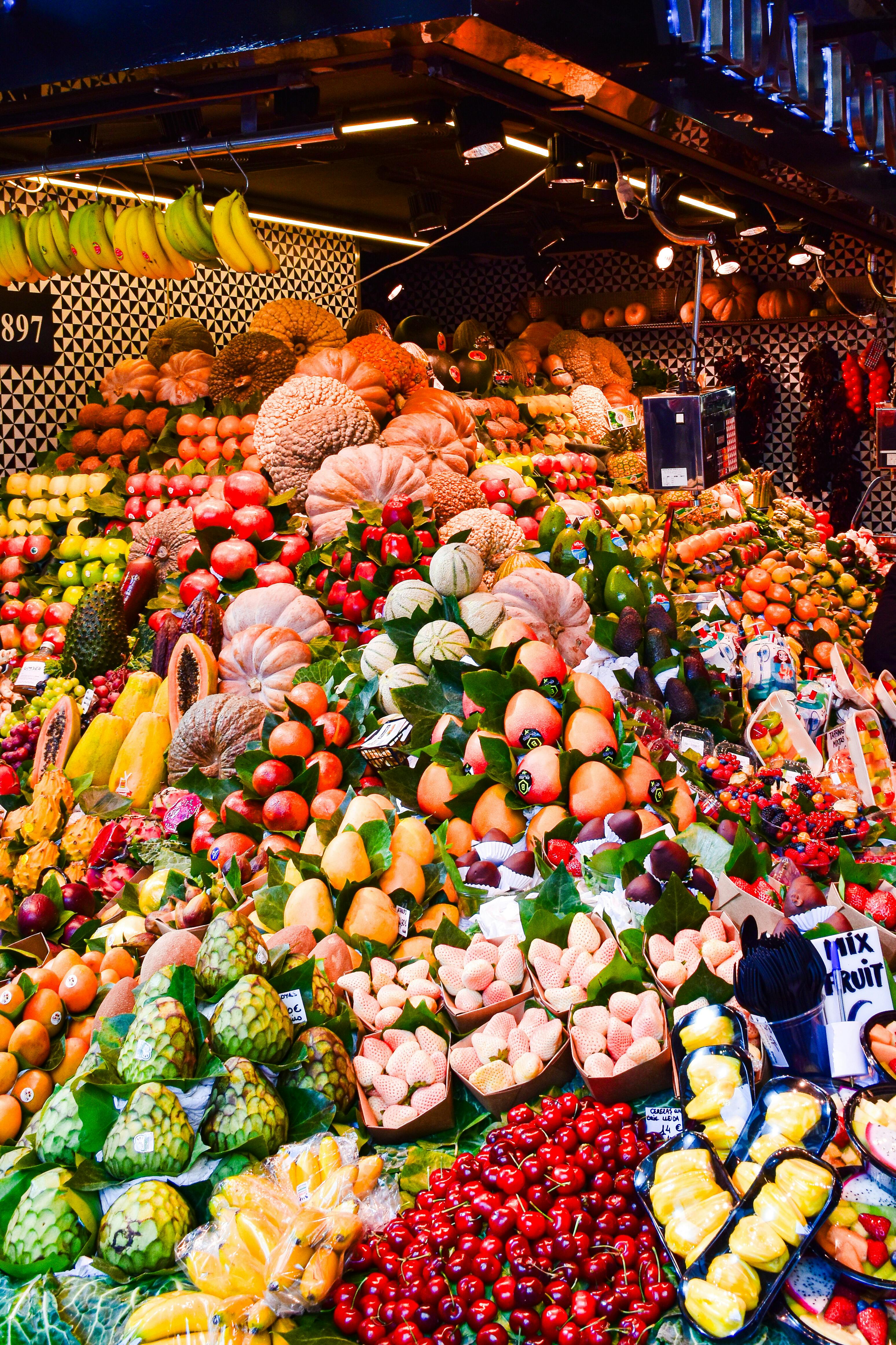 a large display of fruits and vegetables at a market