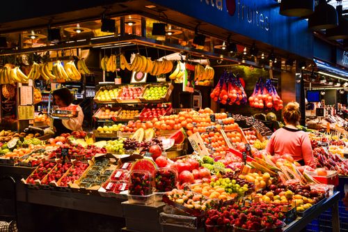Free Colorful fruit display at a bustling market in Barcelona, Spain. Stock Photo
